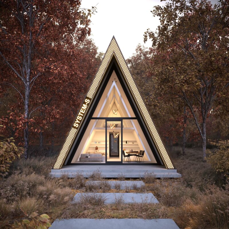 Nowoczesny domek Forest Prism A-frame w jesiennym lesie, z dużym przeszkleniem frontowym i oświetleniem LED, prowadzi do niego ścieżka.