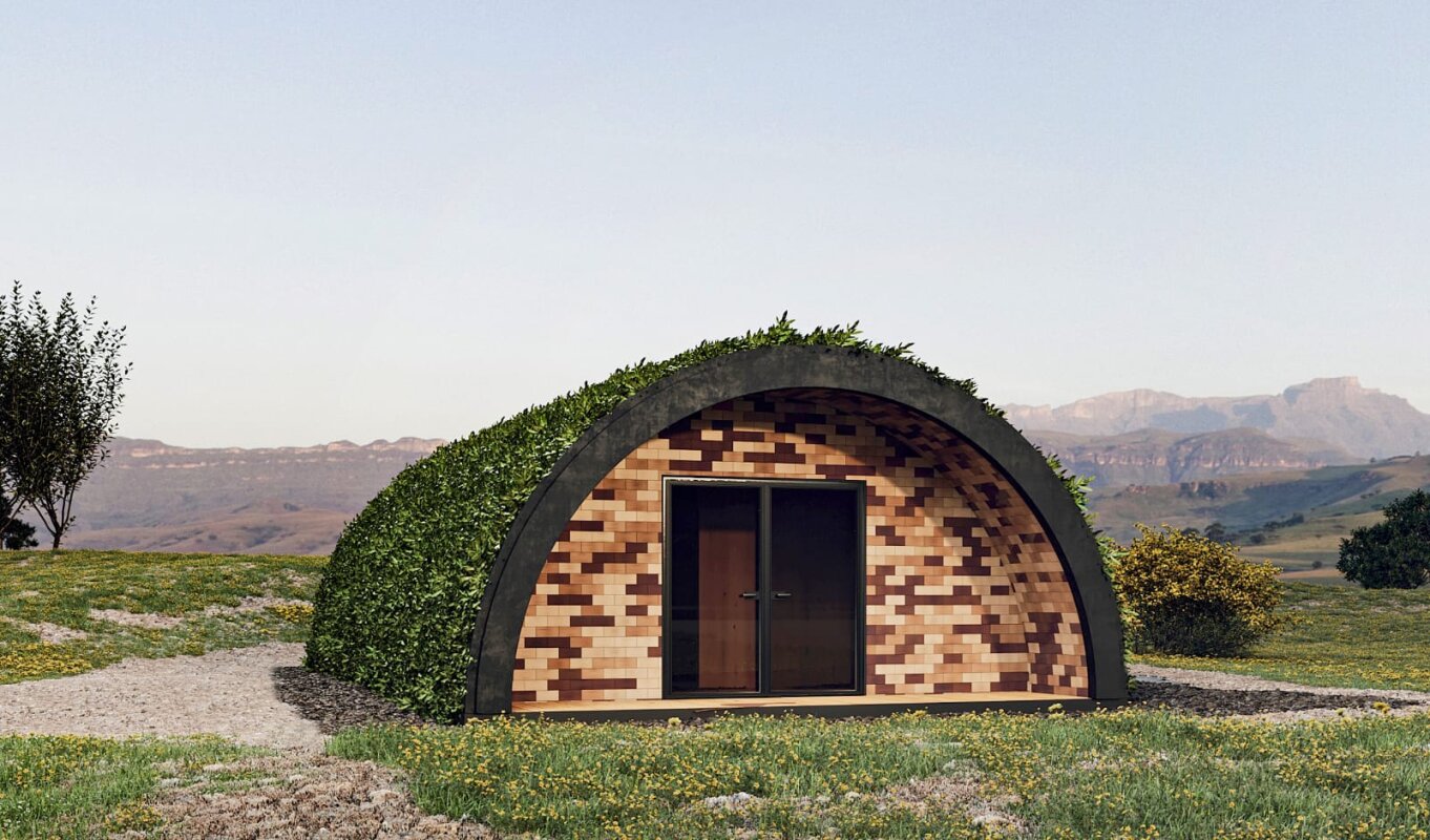 Tunnel House: półkolisty, zielony dach, drewniana fasada.
