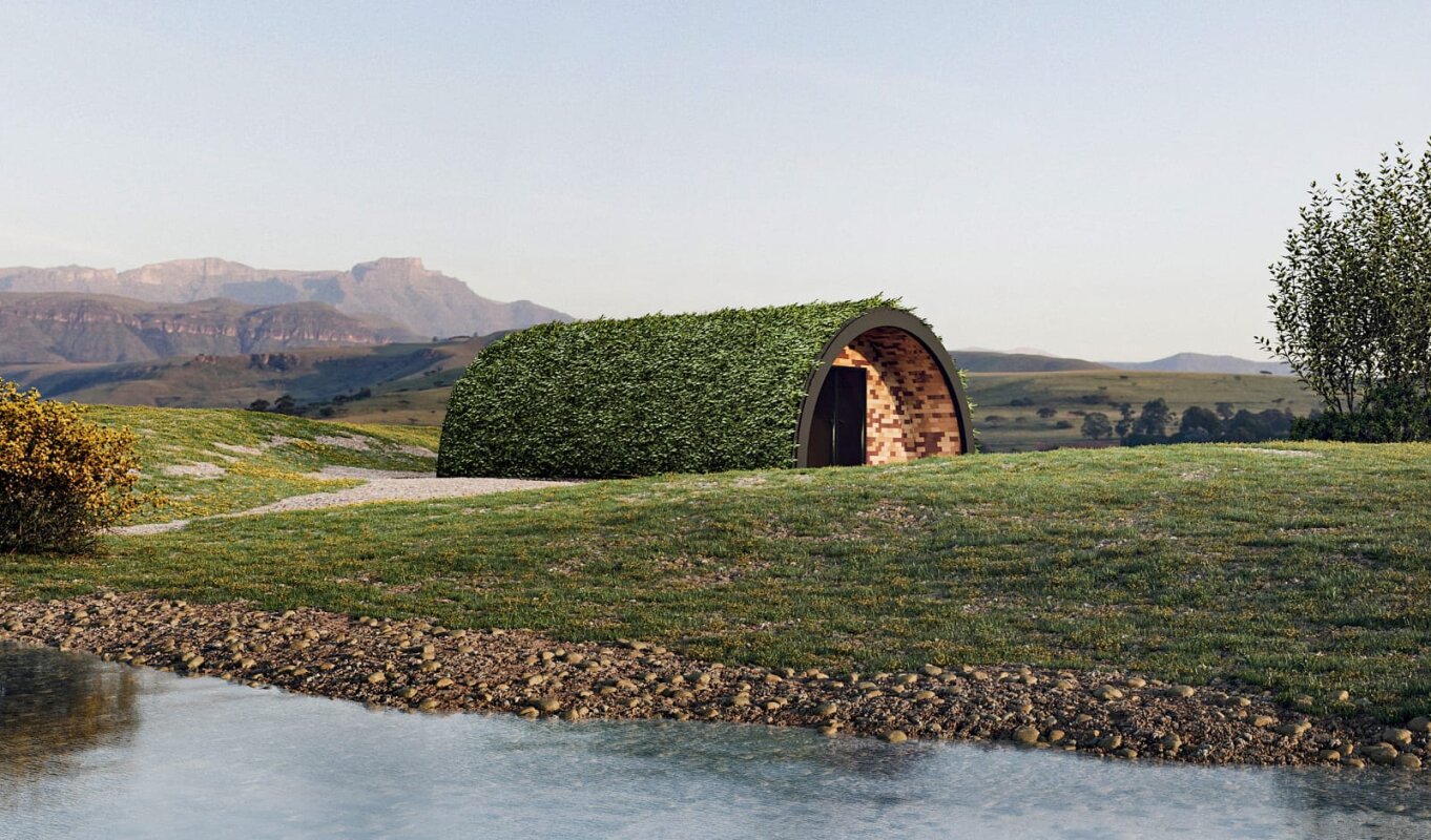 Tunnel House nad wodą: górzysty krajobraz, zielony dach.