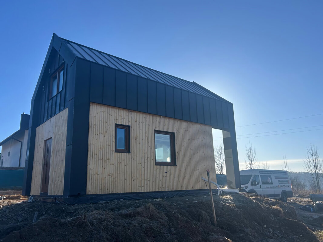 Modern frame house Ekodom 50 in Limanowa; black metal and light wood cladding.
