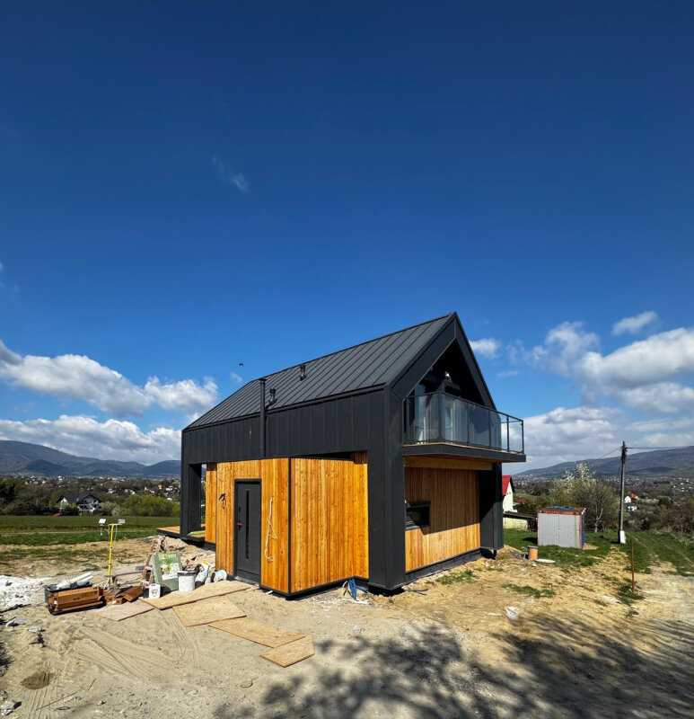 Zewnętrzny widok nowoczesnego domu szkieletowego Ekodom75 z elewacją modrzewiową w Pietrzykowicach